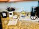Granite kitchen counter featuring small appliances, a utensils caddy, and informational papers for added functionality at 2404 N Ocean Blvd. # 635, Myrtle Beach, SC 29577