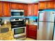 Modern kitchen with stainless steel appliances, granite countertops, and wooden cabinets at 2404 N Ocean Blvd. # 635, Myrtle Beach, SC 29577