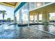 Indoor/outdoor pool with tile flooring, palm trees, lounge chairs and No Diving sign at 2404 N Ocean Blvd. # 635, Myrtle Beach, SC 29577