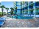 Community pool surrounded by lounge chairs and palm trees adjacent to a tall condominium complex at 2404 N Ocean Blvd. # 635, Myrtle Beach, SC 29577