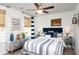 Cozy bedroom featuring a ceiling fan, striped bedding, and natural light from the window at 246 Mayflower Dr., Calabash, NC 28467