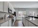 Open kitchen features granite countertops, stainless appliances, and a bright window over the sink at 246 Mayflower Dr., Calabash, NC 28467