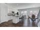 Sunlit kitchen with granite counters, stainless appliances, large island, and open access to the dining area at 246 Mayflower Dr., Calabash, NC 28467