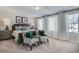 Serene main bedroom features neutral décor, large windows with natural light, and plush carpet flooring at 246 Mayflower Dr., Calabash, NC 28467