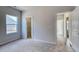 Simple bedroom with neutral carpet, paint, and trim and a window for plenty of light at 250 Mayflower Dr., Calabash, NC 28467