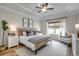 Bright bedroom featuring tray ceiling, wood-look floors, neutral walls, and stylish, curated furniture at 250 Mayflower Dr., Calabash, NC 28467