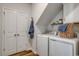 Functional laundry room with modern washer and dryer units and storage at 250 Mayflower Dr., Calabash, NC 28467