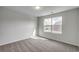 Bright, carpeted bedroom with a large window offering a pleasant view at 261 Mayflower Dr., Calabash, NC 28467