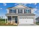 Charming two-story home with a two-car garage and well-maintained landscaping at 261 Mayflower Dr., Calabash, NC 28467