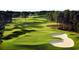 Scenic golf course view featuring sand traps and lush green fairways surrounded by trees at 261 Mayflower Dr., Calabash, NC 28467