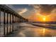 Seascape of a pier over the ocean with a sunset backdrop at 261 Mayflower Dr., Calabash, NC 28467