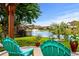 Backyard patio with view of water fountain, lush landscaping, and Adirondack chairs at 274 Avenue Of The Palms, Myrtle Beach, SC 29579