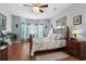 Comfortable bedroom with wooden floors, ceiling fan, neutral walls, and bay window at 274 Avenue Of The Palms, Myrtle Beach, SC 29579