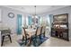Dining area with matching chairs, table cloth, overhead light fixture, and accent wall at 274 Avenue Of The Palms, Myrtle Beach, SC 29579