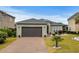 Inviting single-story home featuring a brick driveway, two-car garage, and beautifully maintained lawn at 274 Avenue Of The Palms, Myrtle Beach, SC 29579