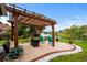 Backyard patio with a wooden pergola, cushioned seating, and a tranquil water fountain at 274 Avenue Of The Palms, Myrtle Beach, SC 29579