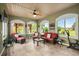 Bright sunroom with comfortable seating, multiple windows, tile flooring, and a ceiling fan at 274 Avenue Of The Palms, Myrtle Beach, SC 29579