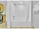 Clean bathroom with a shower-tub combo, white tile surround, and updated fixtures at 3000 N Ocean Blvd. # 220, Myrtle Beach, SC 29577