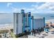 Oceanfront condo with a striking blue and white exterior, multiple floors, and an ocean view at 3000 N Ocean Blvd. # 220, Myrtle Beach, SC 29577