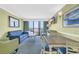 Cozy living room with a comfortable blue sofa, a dining table, and balcony access with ocean views at 3000 N Ocean Blvd. # 220, Myrtle Beach, SC 29577