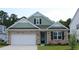 Beautiful exterior of a home featuring stone accents, a two-car garage, and manicured landscaping at 333 Glacier Way, Conway, SC 29526