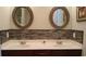 Elegant bathroom with dual sinks, granite countertops, and decorative wall-mounted mirrors at 3358 Pampas Dr., Myrtle Beach, SC 29577