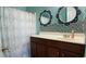 Cozy bathroom featuring a vanity, decorative mirrors, and a shower with a stylish curtain at 3358 Pampas Dr., Myrtle Beach, SC 29577