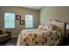Bright bedroom with a plush bed, palm tree bedding, natural light, and a relaxing atmosphere at 3358 Pampas Dr., Myrtle Beach, SC 29577