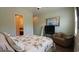 Cozy bedroom with comfortable chair, television, and a serene view of the ensuite bathroom at 3358 Pampas Dr., Myrtle Beach, SC 29577