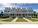 Street view of townhouses, each with unique pastel color and landscaping at 3358 Pampas Dr., Myrtle Beach, SC 29577