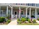 Townhouse with decorative front porch, American flag, and well-maintained landscaping at 3358 Pampas Dr., Myrtle Beach, SC 29577