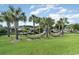Serene hammock area surrounded by palm trees and green grass, offering a peaceful retreat at 3358 Pampas Dr., Myrtle Beach, SC 29577