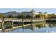 Scenic waterfront view featuring a pedestrian bridge and reflections of buildings on the water at 3358 Pampas Dr., Myrtle Beach, SC 29577