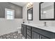 Bathroom featuring double vanity with dark cabinets, decorative tile, and stylish lighting at 383 Hayloft Circle, Conway, SC 29526