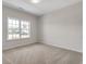 A bedroom with neutral walls and carpet has a bright window for natural light at 383 Hayloft Circle, Conway, SC 29526