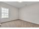 This bedroom features neutral carpeting and a bright window overlooking the green yard at 383 Hayloft Circle, Conway, SC 29526