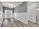Stylish foyer featuring white wainscoting, wood-look floors, and a modern chandelier at 383 Hayloft Circle, Conway, SC 29526