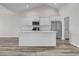 Bright kitchen with white cabinets, stainless steel appliances, and an island with quartz countertops at 383 Hayloft Circle, Conway, SC 29526