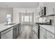 Modern kitchen featuring quartz countertops and stainless steel appliances adjacent to the breakfast nook at 383 Hayloft Circle, Conway, SC 29526