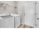 Bright laundry room equipped with a washer, a dryer, and wire shelving at 383 Hayloft Circle, Conway, SC 29526