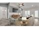 Bright living room with stylish furnishings, modern ceiling fan, and a decorative media cabinet at 383 Hayloft Circle, Conway, SC 29526