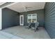Covered patio with two chairs is the perfect place to relax and enjoy fresh air at 383 Hayloft Circle, Conway, SC 29526