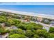 Aerial view showing the home's proximity to the beach and featuring beautiful landscaping and nearby buildings at 4003 N Ocean Blvd., Myrtle Beach, SC 29577