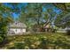 Expansive backyard featuring a pool, guest house, and mature trees, offering ample space for outdoor activities at 4003 N Ocean Blvd., Myrtle Beach, SC 29577