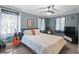 Well-lit bedroom with neutral walls, ceiling fan, carpeted floors, and two windows at 4003 N Ocean Blvd., Myrtle Beach, SC 29577