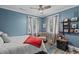 Cozy bedroom with two windows, a chair, shelves, and carpet flooring at 4003 N Ocean Blvd., Myrtle Beach, SC 29577