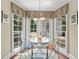 Bright breakfast nook with glass table and chairs, surrounded by windows with backyard views at 4003 N Ocean Blvd., Myrtle Beach, SC 29577
