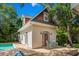 Charming guest house with rocking chairs, complemented by landscaping, situated near the pool and main house at 4003 N Ocean Blvd., Myrtle Beach, SC 29577