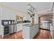 Spacious kitchen with stainless steel appliances, granite countertops, and pot rack above central island at 4003 N Ocean Blvd., Myrtle Beach, SC 29577