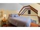Loft bedroom featuring a comfortable bed, warm lighting, and wood floors at 4003 N Ocean Blvd., Myrtle Beach, SC 29577